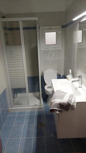 a bathroom with a toilet and a sink and a shower at Thanos home corfu in Kynopiástai