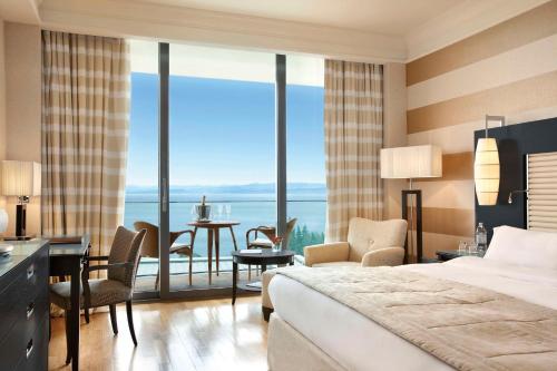 a hotel room with a bed and a view of the ocean at Kempinski Hotel Adriatic Istria Croatia in Savudrija