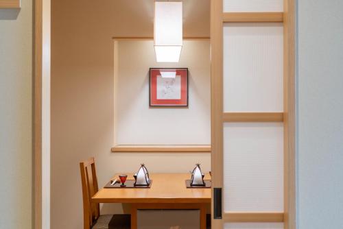 a dining room with a table and a light at Omuro no Mori Gyokusui -13 years or older- in Ito
