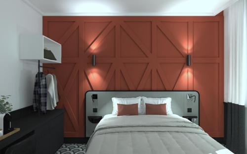 a bedroom with a large red headboard and a bed at Logis Hotel Darcy Dijon Centre in Dijon