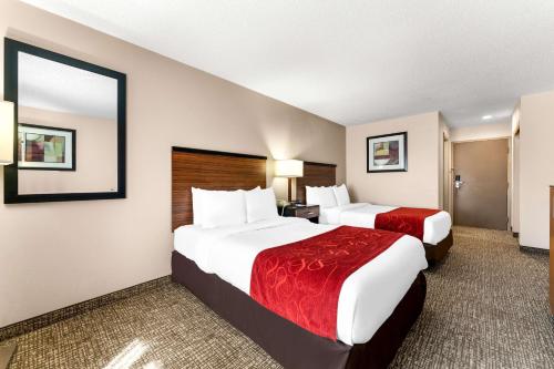 a hotel room with two beds and a bathroom at SureStay Plus by Best Western Reading North in Reading