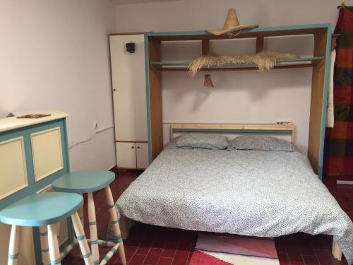 a bedroom with a bed and two stools at Studio Cotta, Salara farmhouse in Koper