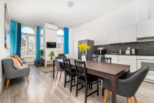 a kitchen and dining room with a table and chairs at Racoczy 5BR 3BR Cozy Getaway in Budapest
