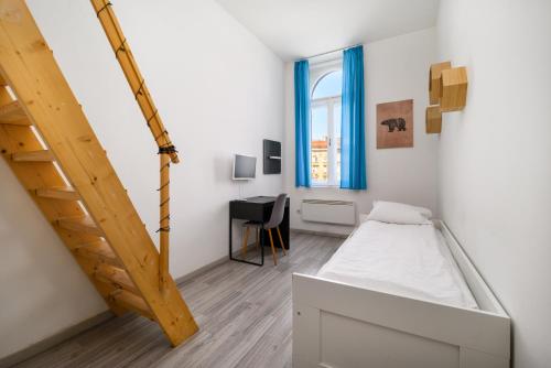 a small room with a bed and a ladder at Racoczy 5BR 3BR Cozy Getaway in Budapest
