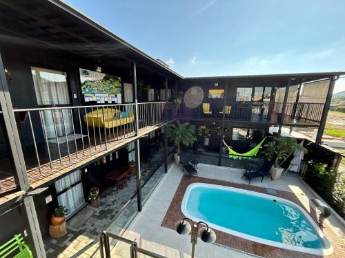 a balcony with a swimming pool on a building at Pousada Canto do Gravatá in Penha