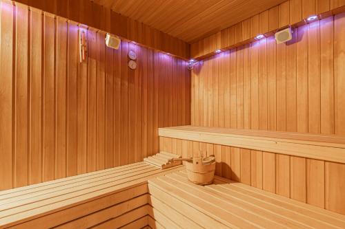 a sauna with wooden paneling and purple lights at Apartments Lavrič in Velike Bloke