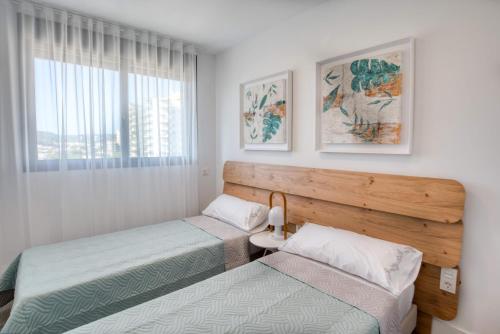 a bedroom with two beds and a window at Penthouse on the first line in Platja d'Aro