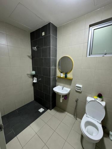 a bathroom with a toilet and a sink at Skylake Residence Luxury Family Vacation in Puchong