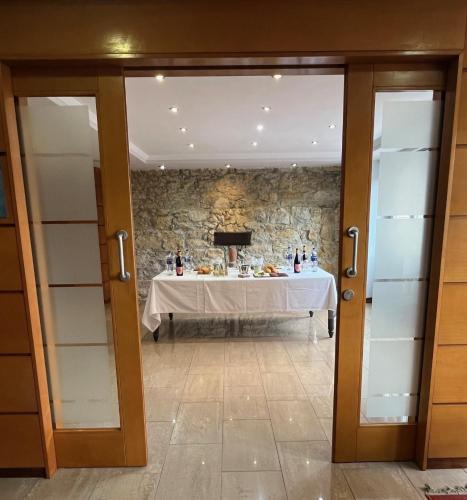 a table in a room with a stone wall at Hotel Gran Regente in Oviedo