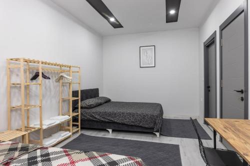 a living room with a bed and a table at 7-Şehir Merkezinde 4 Yatak Odalı Dubleks Daire in Antalya