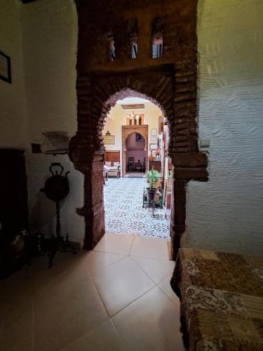 a hallway with an arch way in a house at Dar Si hmed in Rabat