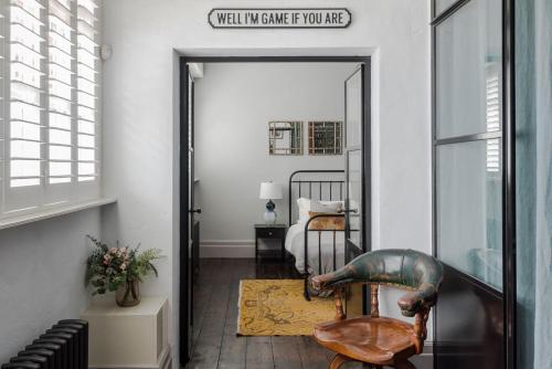 a hallway with a chair and a mirror at Magic Moments - London Bridge - by Frankie Says in London