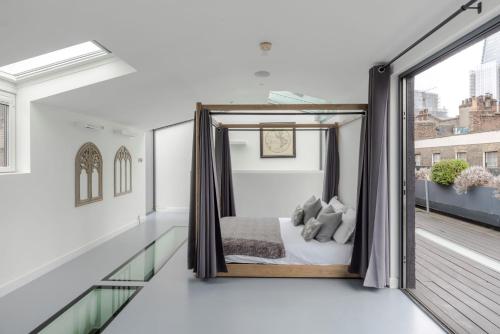 a bedroom with a bed on a balcony at Magic Moments - London Bridge - by Frankie Says in London