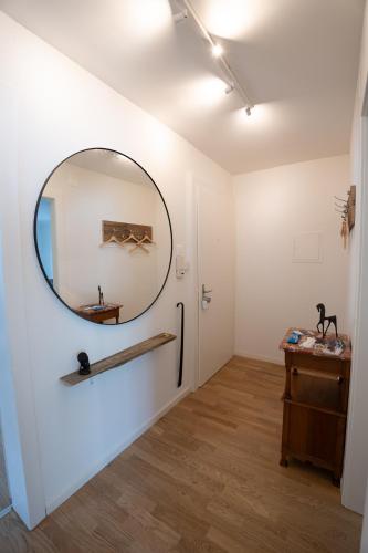 a room with a mirror on the wall and a table at Jungstay Apartments- near Basel in Basel