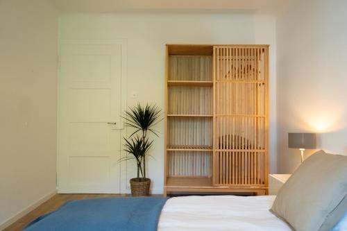 a bedroom with a bed and a book shelf at Jungstay Apartments- near Basel in Basel