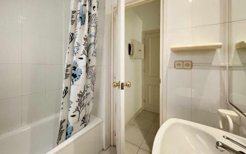 a bathroom with a sink and a shower curtain at Nautic wifi Parking y a 150 metros de la playa in Tossa de Mar