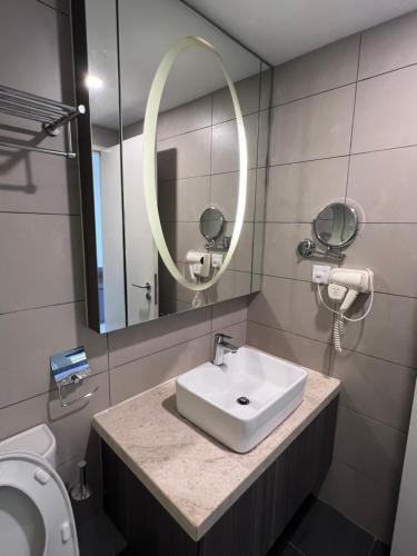 a bathroom with a sink and a mirror and a toilet at Grand Ion Delemen by 91 Homestay in Genting Highlands