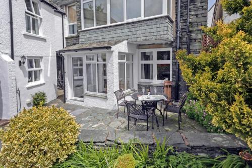a patio with a table and chairs in front of a house at Keswick View in Keswick