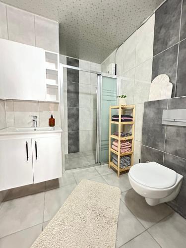 La salle de bains est pourvue de toilettes, d'un lavabo et d'une douche. dans l'établissement Lüks Konforlu ve merkezi ev, à Çiftlikköy
