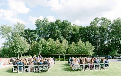 a group of people sitting in chairs at a ceremony at Delamar West Hartford in West Hartford
