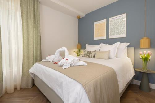 a bedroom with a bed with two stuffed animals on it at Makarska City Bay Studios in Makarska