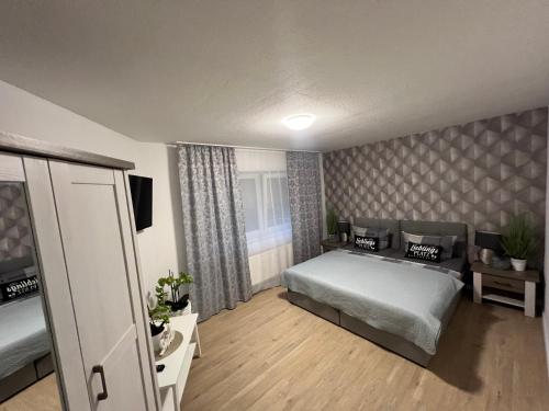 a bedroom with a bed and a television in it at Ferienwohnung Viktoria in Gotha
