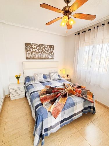 a bedroom with a bed with a ceiling fan at Villa Sol Ciudad Quesada in Ciudad Quesada