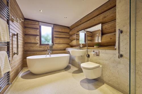 uma casa de banho com uma banheira, um WC e um lavatório. em Alder Lodge with Hot-tub em Carlisle