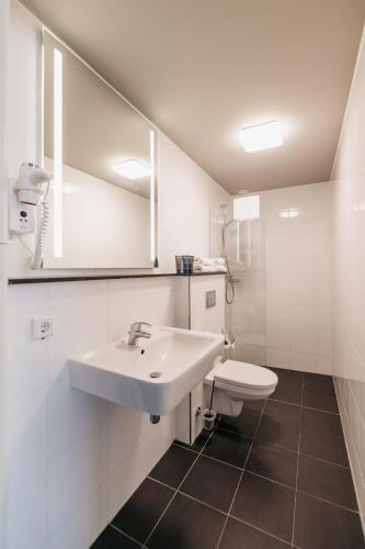 a bathroom with a sink and a toilet at YAYS Amsterdam Maritime by Numa in Amsterdam