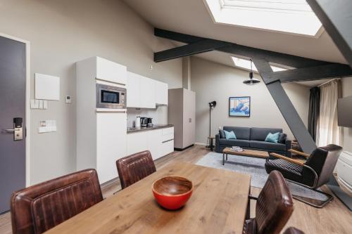 a kitchen and living room with a table and chairs at YAYS Amsterdam Maritime by Numa in Amsterdam
