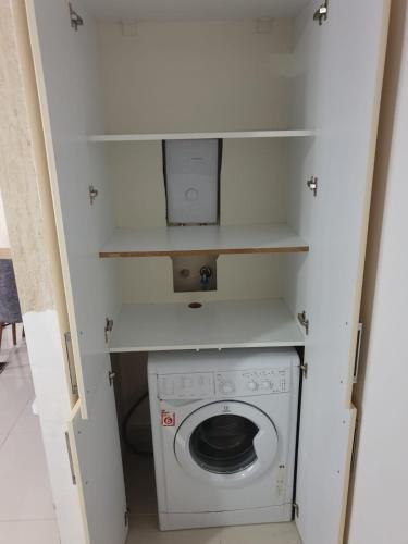 a small bathroom with a washing machine in it at AQUA CİTY SUİT in Antalya