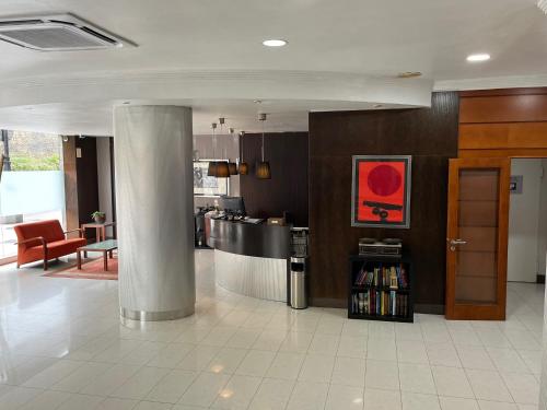 a large room with a kitchen and a living room at Hotel Gran Regente in Oviedo