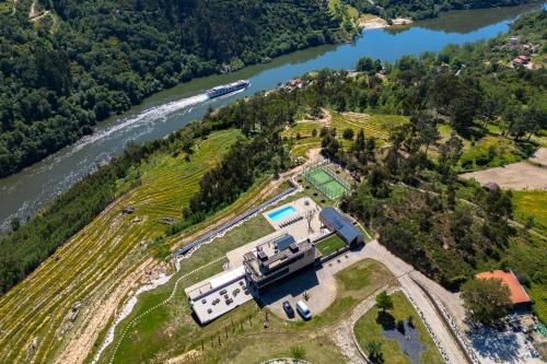 an aerial view of a house next to a river at Quinta de Cabanas Douro Country House in Penha Longa