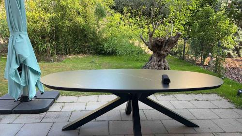 a surfboard sitting on a table next to a tree at House Susanne in Cologne