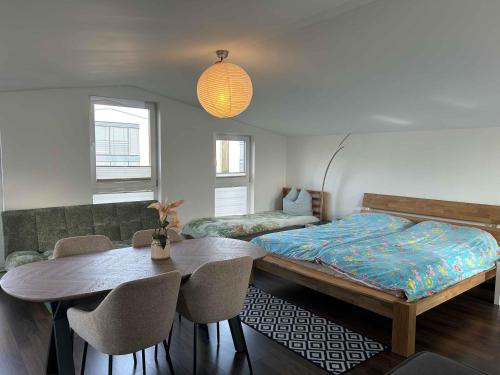 a bedroom with a bed and a table and chairs at House Susanne in Cologne