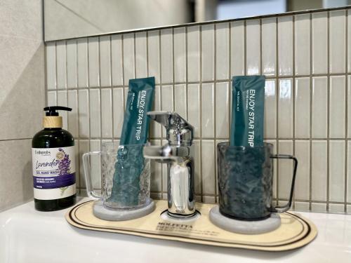 a bathroom counter with two bottles of soap and a sink at Lai Jie Accommodation新北市民宿411號 in Tamsui