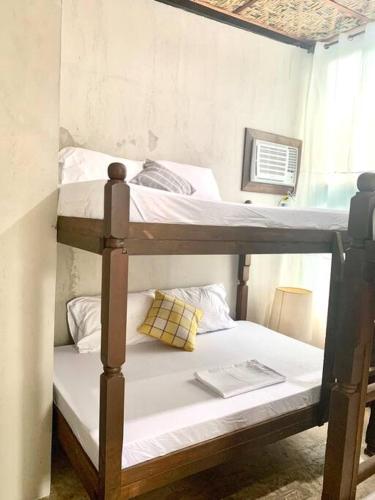 two bunk beds in a room with a book at 940 Dahlia near Daang Hari in Manila