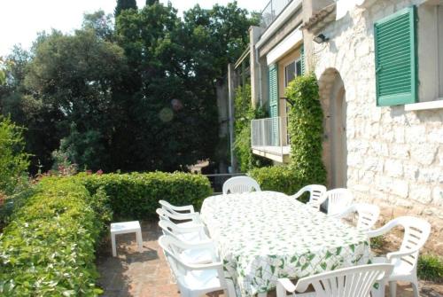 a table and chairs in front of a building at Ferienhaus in Garda mit Garten, Grill und Terrasse in Garda