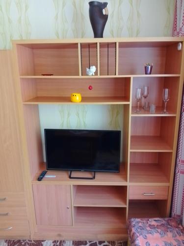 - une étagère en bois avec une télévision dans l'établissement Namas, à Klaipėda