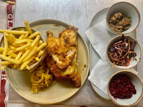 a plate of food with a chicken and french fries at The Golden Cross in Cirencester
