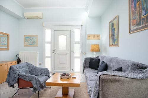 a living room with a couch and a table at Art of urban hospitality! in Mytilini
