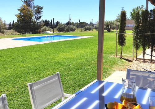 a blue table with fruit on it next to a pool at Casa Pascal cœur du Delta in L'Ampolla
