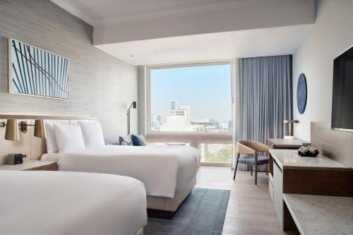 a hotel room with two beds and a large window at JW Marriott Hotel Mexico City Polanco in Mexico City