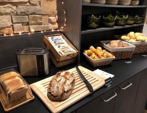 a kitchen with a loaf of bread and other foods at Ski- & Sonnenresort Alpendorf by AlpenTravel in Sankt Johann im Pongau