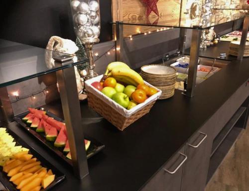 a counter with a basket of fruit on it at Ski- & Sonnenresort Alpendorf by AlpenTravel in Sankt Johann im Pongau