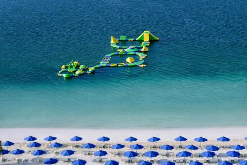 a plane on the water next to a beach at Mövenpick Resort Al Marjan Island in Ras al Khaimah