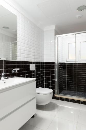 a bathroom with a toilet and a sink and a shower at Seraph by ON Travel in Oliva