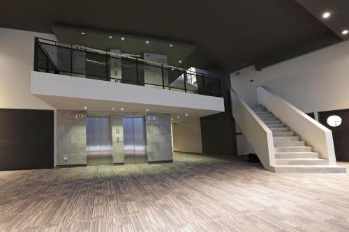 an empty room with stairs and a stair case at Hotel Cumbres Lastarria in Santiago