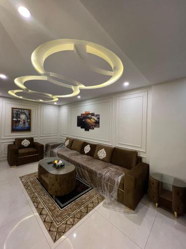 sala de estar con sofá y lámpara de araña en Luxury 1-Bed Apartment Bahria en Lahore