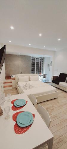 a living room with a table with plates on it at BARBARA Classy Apartments 103, Wellness in Siracusa